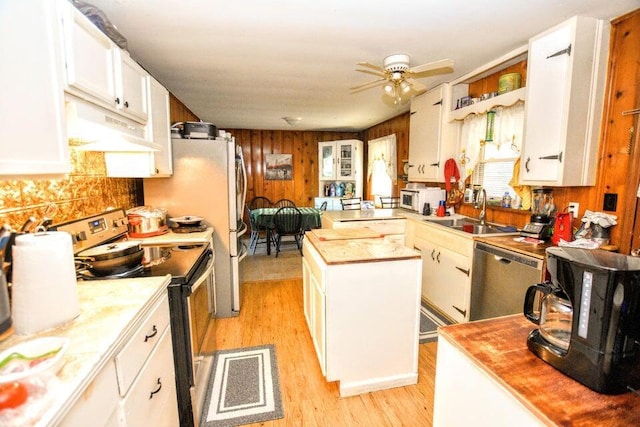 kitchen with ceiling fan, light hardwood / wood-style floors, sink, stainless steel appliances, and white cabinets