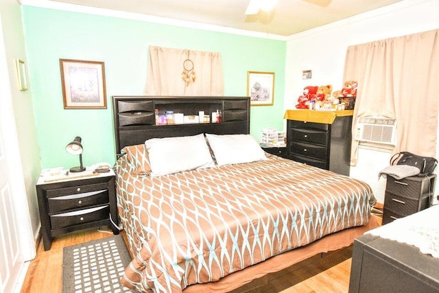 bedroom with ceiling fan, light wood-type flooring, ornamental molding, and cooling unit