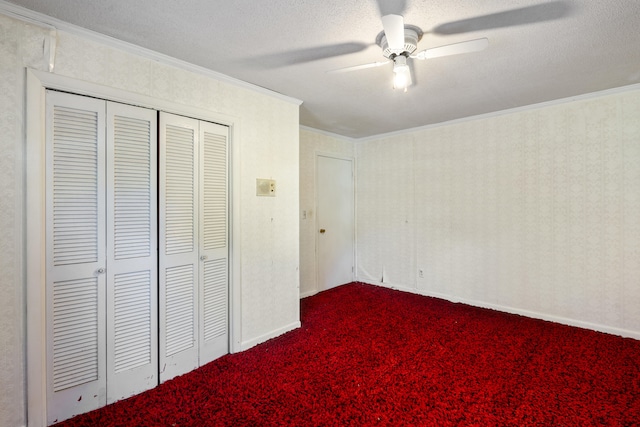 unfurnished bedroom featuring a textured ceiling, carpet floors, ceiling fan, and ornamental molding