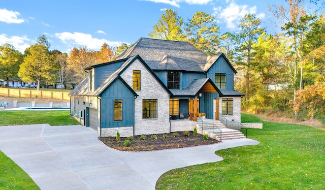 view of front of property featuring a garage and a front lawn