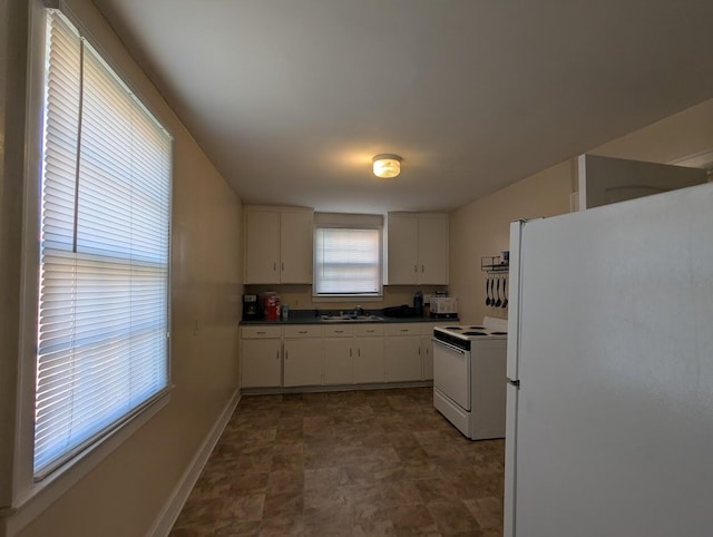 525 4th St NW, Cleveland, TN 37311 - kitchen featuring white appliances, dark countertops, white cabinetry, and stone finish floors