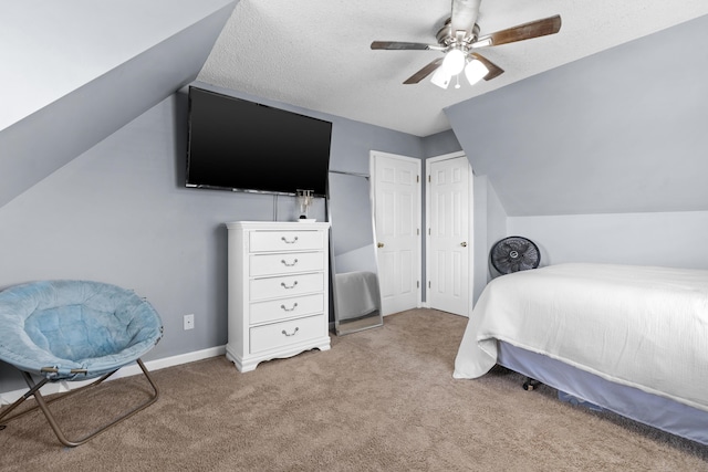 bedroom featuring vaulted ceiling, baseboards, carpet floors, and a textured ceiling