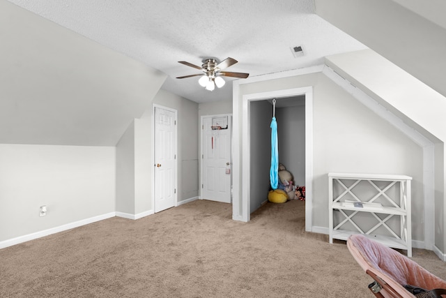 bonus room with a ceiling fan, baseboards, visible vents, a textured ceiling, and carpet flooring