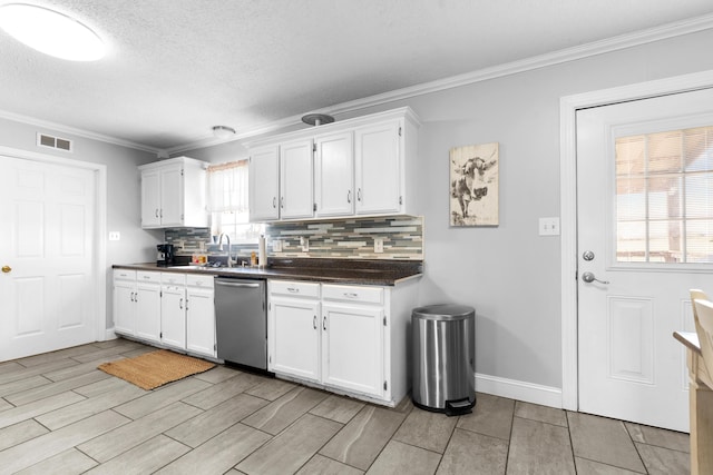 kitchen featuring dark countertops, visible vents, white cabinets, and stainless steel dishwasher