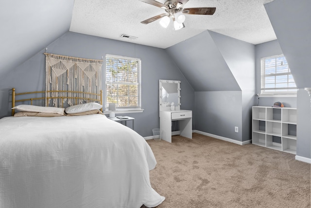 carpeted bedroom featuring multiple windows, baseboards, visible vents, and a textured ceiling