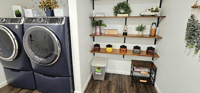 clothes washing area featuring separate washer and dryer and dark hardwood / wood-style flooring