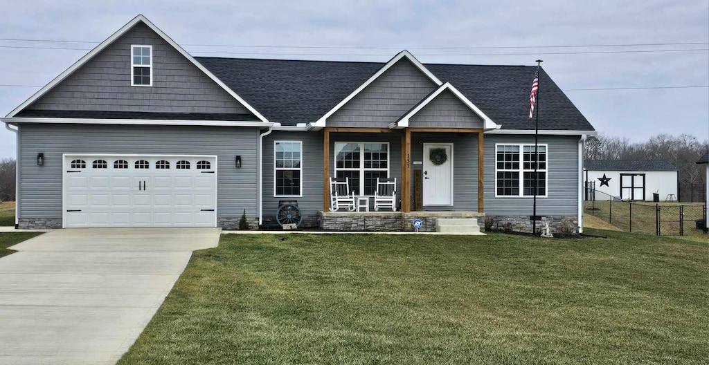 craftsman-style house with a garage and a front lawn