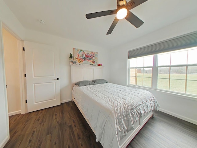 bedroom with ceiling fan and dark hardwood / wood-style flooring