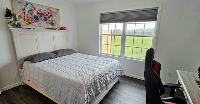 bedroom with dark hardwood / wood-style floors