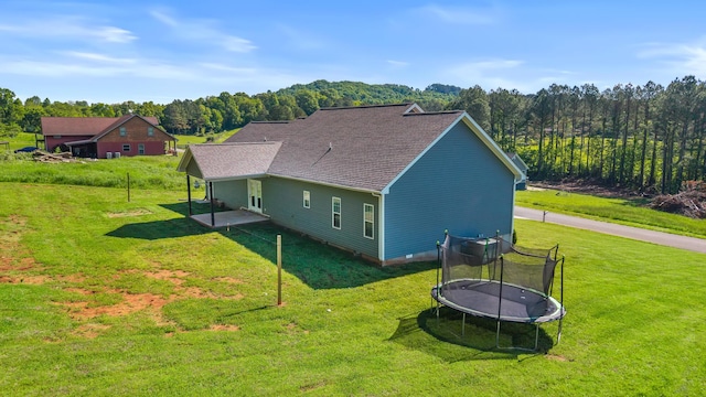 123 Tommy Loop, Sweetwater, TN 37874 - view of property exterior with a trampoline, a lawn, and a patio area