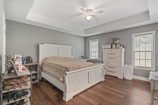 123 Tommy Loop, Sweetwater, TN 37874 - bedroom with a raised ceiling, dark wood-type flooring, multiple windows, and ceiling fan