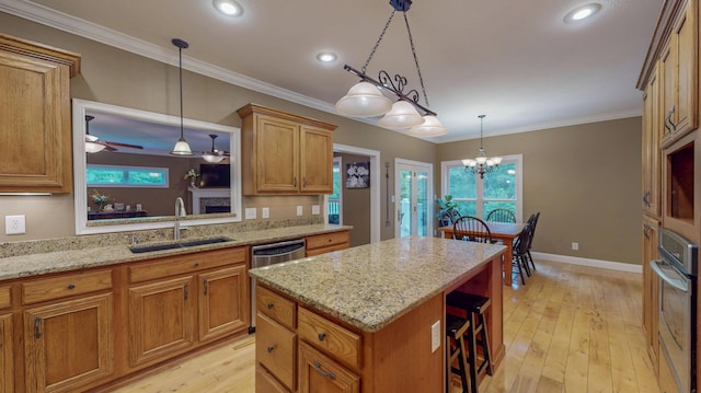 101 NW Amherst Way, Cleveland, TN 37312 - kitchen with stainless steel appliances, a kitchen island, light wood-style flooring, brown cabinets, and a breakfast bar area