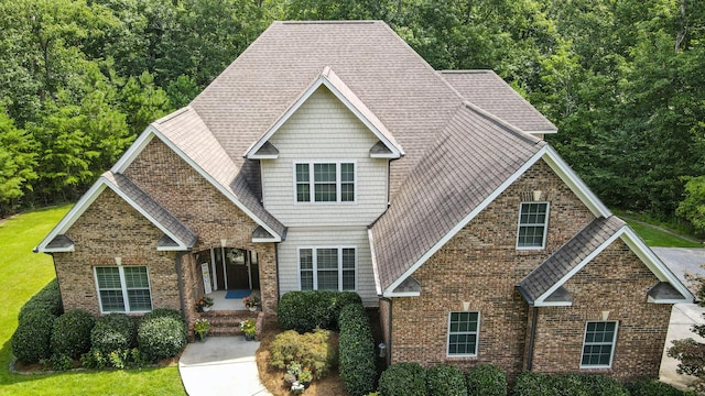 101 NW Amherst Way, Cleveland, TN 37312 - craftsman-style home with brick siding, a front yard, and roof with shingles