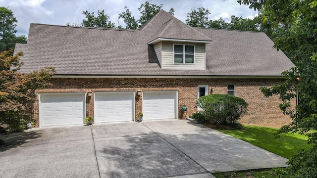 101 NW Amherst Way, Cleveland, TN 37312 - view of front of property with driveway, brick siding, a garage, and a shingled roof