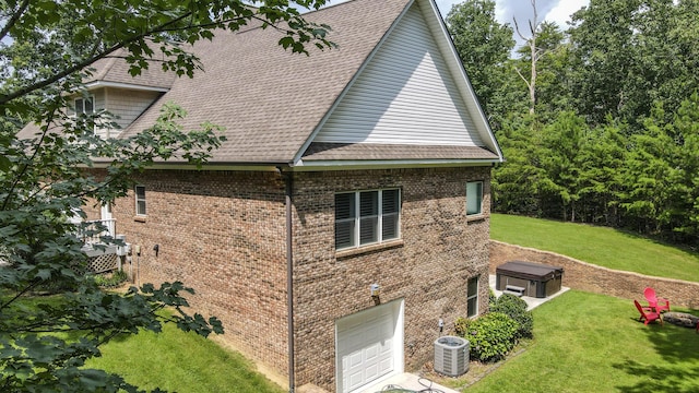 101 NW Amherst Way, Cleveland, TN 37312 - view of side of property featuring a garage, brick siding, a lawn, and roof with shingles