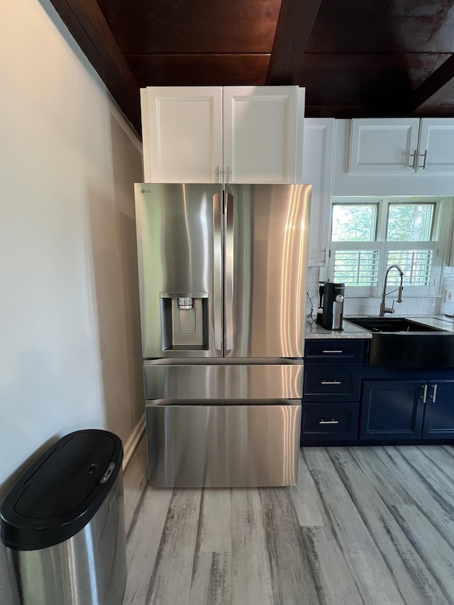 105 Hicks Adams Dr, Reliance, TN 37369 - kitchen featuring stainless steel fridge, a sink, light wood-type flooring, white cabinets, and beam ceiling