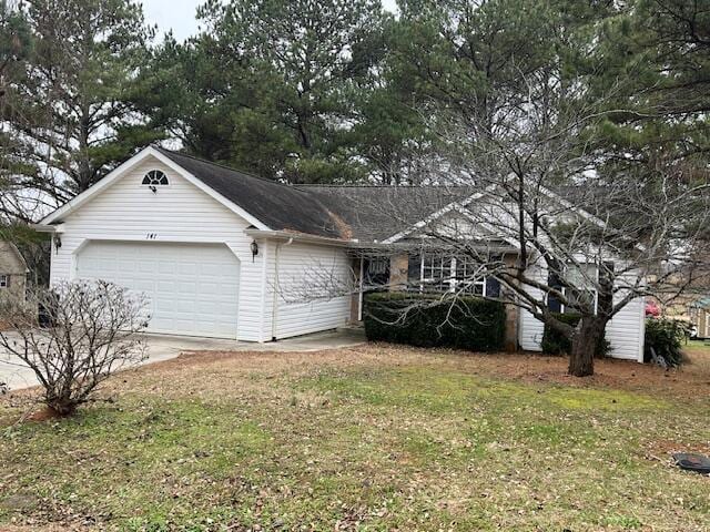 single story home featuring a garage and a front lawn