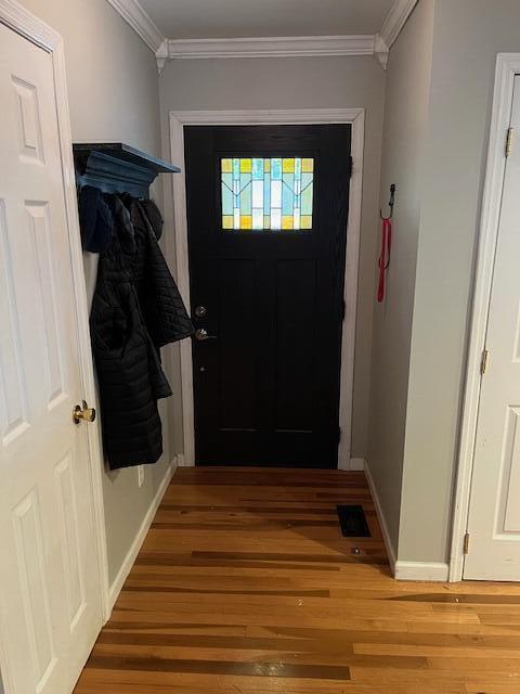 entryway featuring crown molding and hardwood / wood-style floors