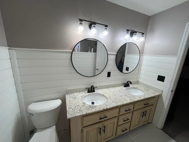 bathroom featuring tile patterned flooring, vanity, and toilet