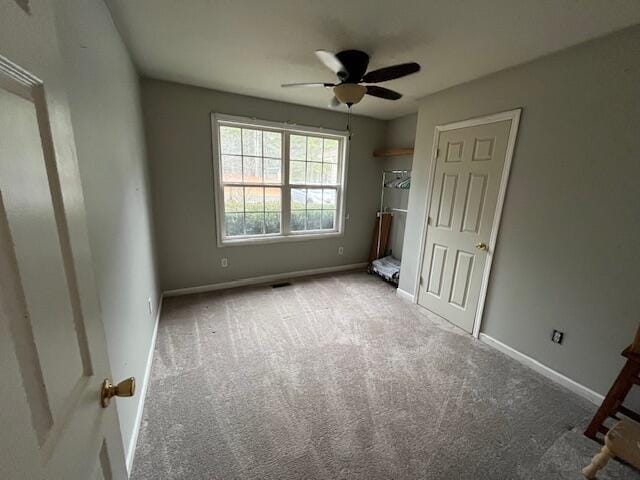 unfurnished bedroom featuring carpet flooring and ceiling fan