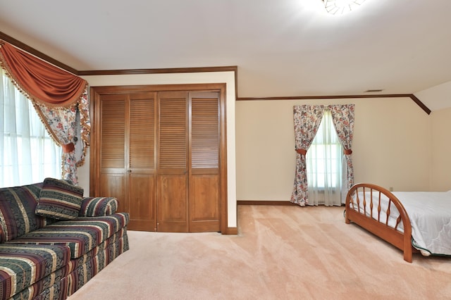 bedroom featuring vaulted ceiling, baseboards, visible vents, crown molding, and carpet floors