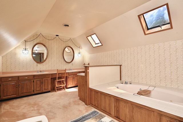 bathroom with a sink, visible vents, vaulted ceiling with skylight, wallpapered walls, and a garden tub
