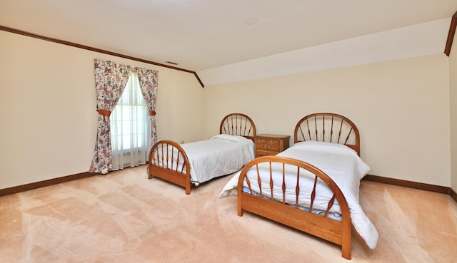 bedroom with carpet floors, vaulted ceiling, and baseboards