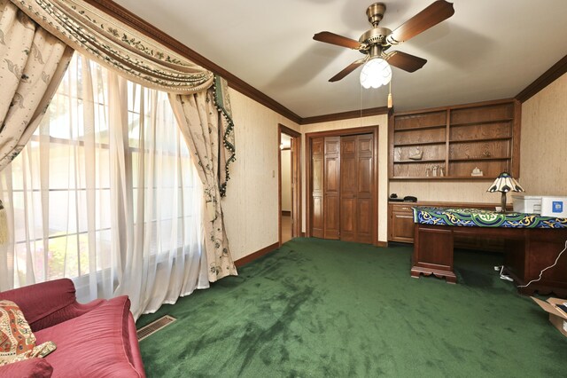 interior space with dark carpet, a ceiling fan, crown molding, and visible vents