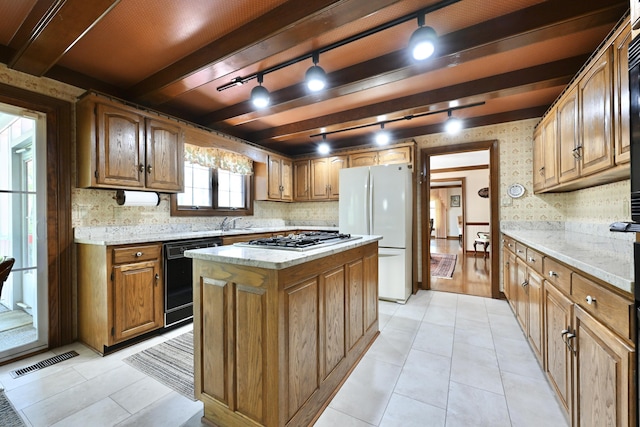 kitchen with tasteful backsplash, visible vents, freestanding refrigerator, black dishwasher, and track lighting
