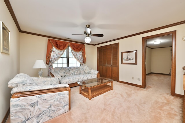 living area with visible vents, baseboards, light colored carpet, a ceiling fan, and ornamental molding