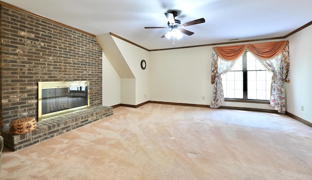 unfurnished living room with ceiling fan, carpet floors, crown molding, and a brick fireplace