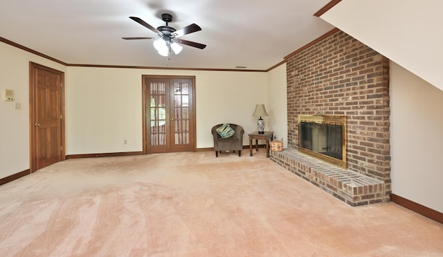 unfurnished living room featuring a ceiling fan, crown molding, carpet floors, baseboards, and a brick fireplace