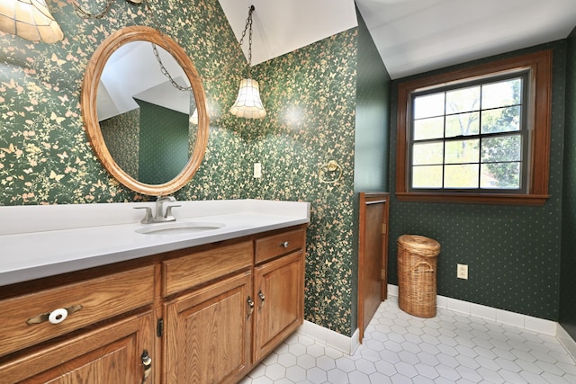 bathroom featuring wallpapered walls, vanity, tile patterned floors, and baseboards