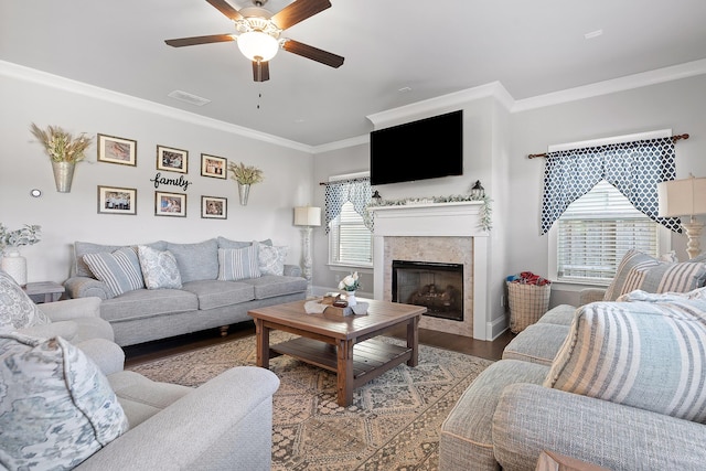 living room with dark wood-type flooring, ornamental molding, and ceiling fan