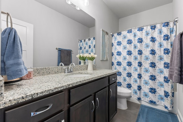 bathroom with tile patterned flooring, vanity, and toilet