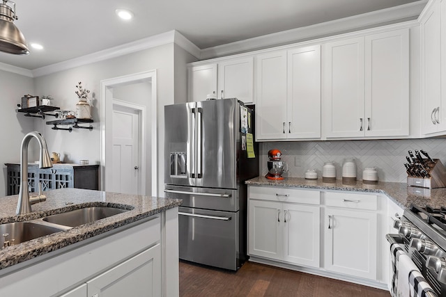 kitchen featuring appliances with stainless steel finishes, sink, and white cabinets