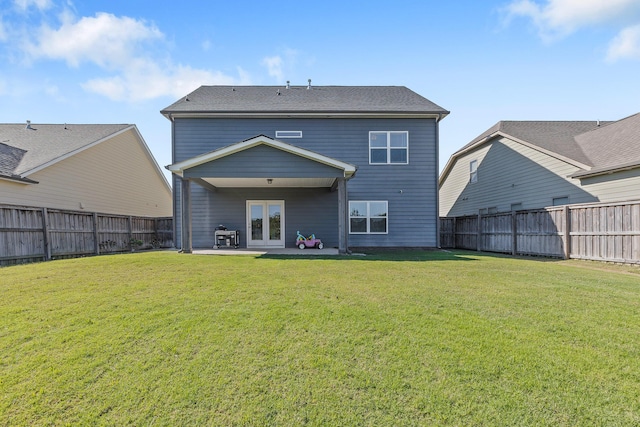 back of house featuring french doors, a yard, and a patio