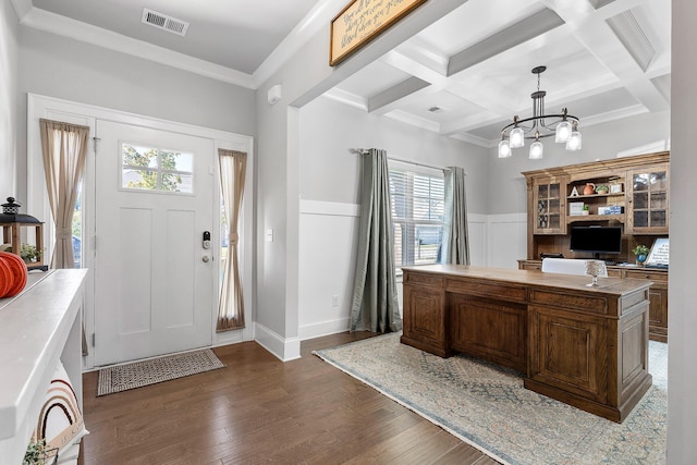 home office featuring dark hardwood / wood-style floors, beamed ceiling, ornamental molding, coffered ceiling, and a notable chandelier