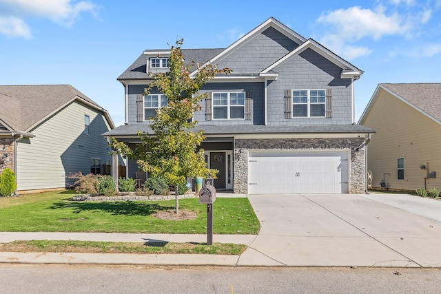 craftsman house with a garage and a front lawn