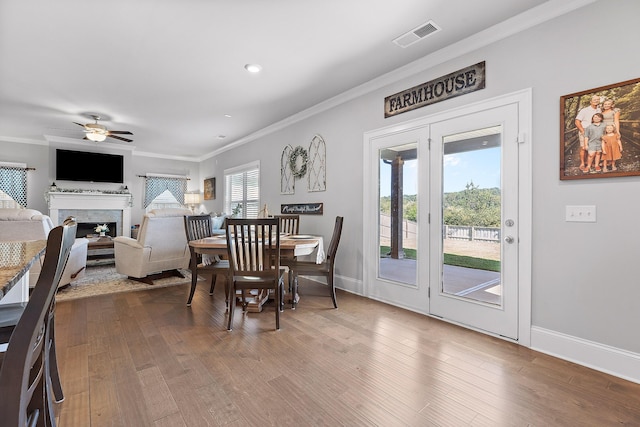 dining space with crown molding, ceiling fan, and hardwood / wood-style floors