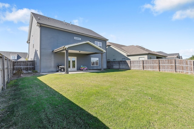 back of property with a patio and a lawn