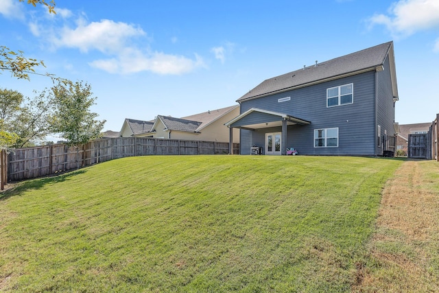 rear view of property with a yard