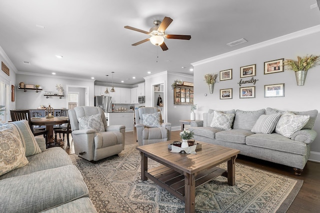 living room with crown molding, dark wood-type flooring, and ceiling fan