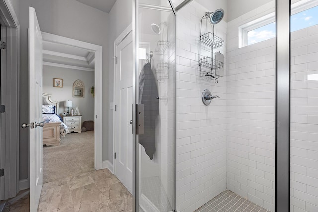 bathroom featuring a tray ceiling, crown molding, and walk in shower