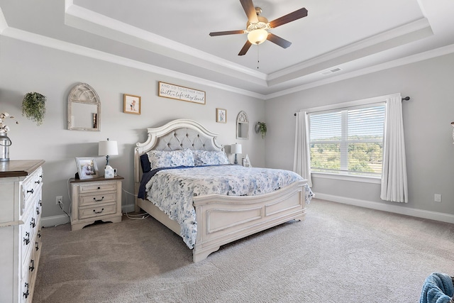 bedroom featuring ornamental molding, carpet flooring, ceiling fan, and a tray ceiling