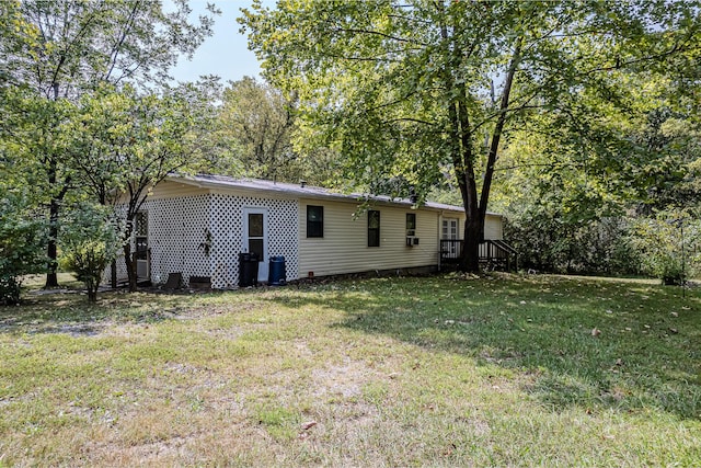 back of property featuring a lawn