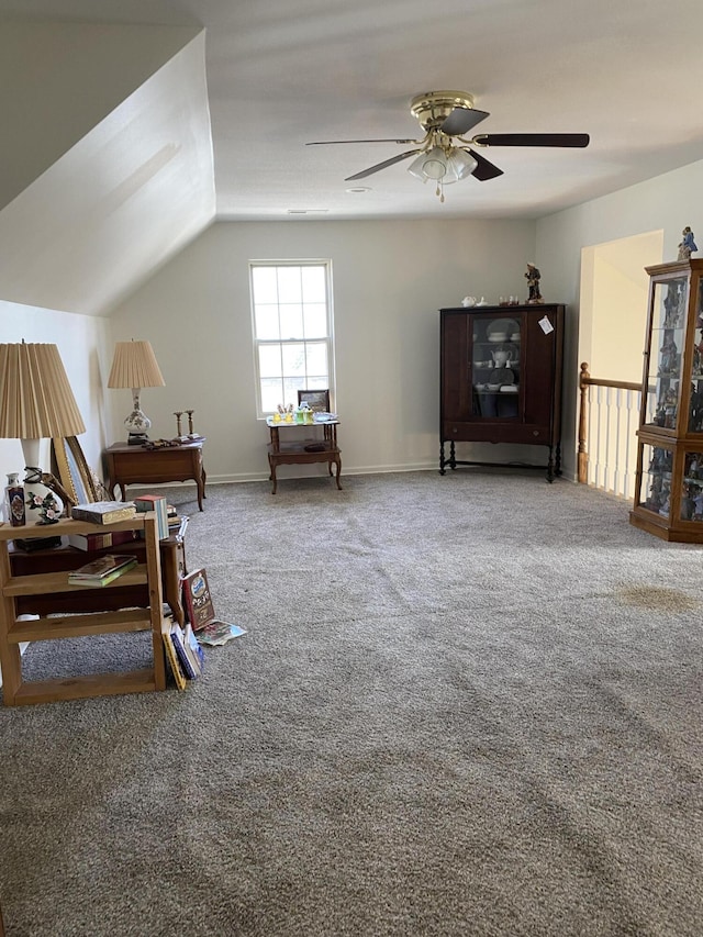 interior space featuring vaulted ceiling, a ceiling fan, and baseboards