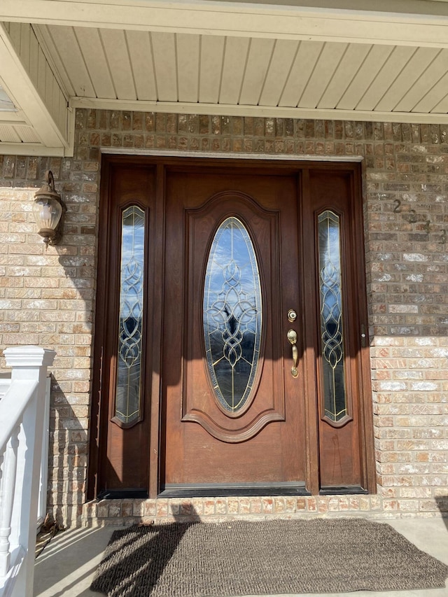 view of exterior entry with brick siding