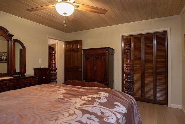 bedroom with wooden ceiling, crown molding, light hardwood / wood-style flooring, ceiling fan, and a closet