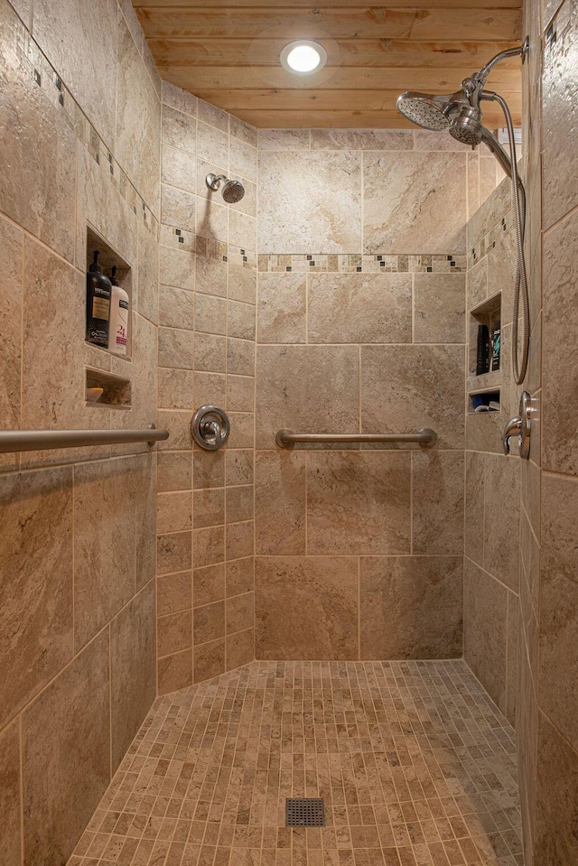 bathroom featuring wood ceiling and tiled shower